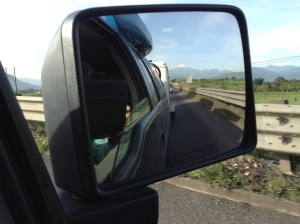 Snow topped volcano in the rearview mirror.